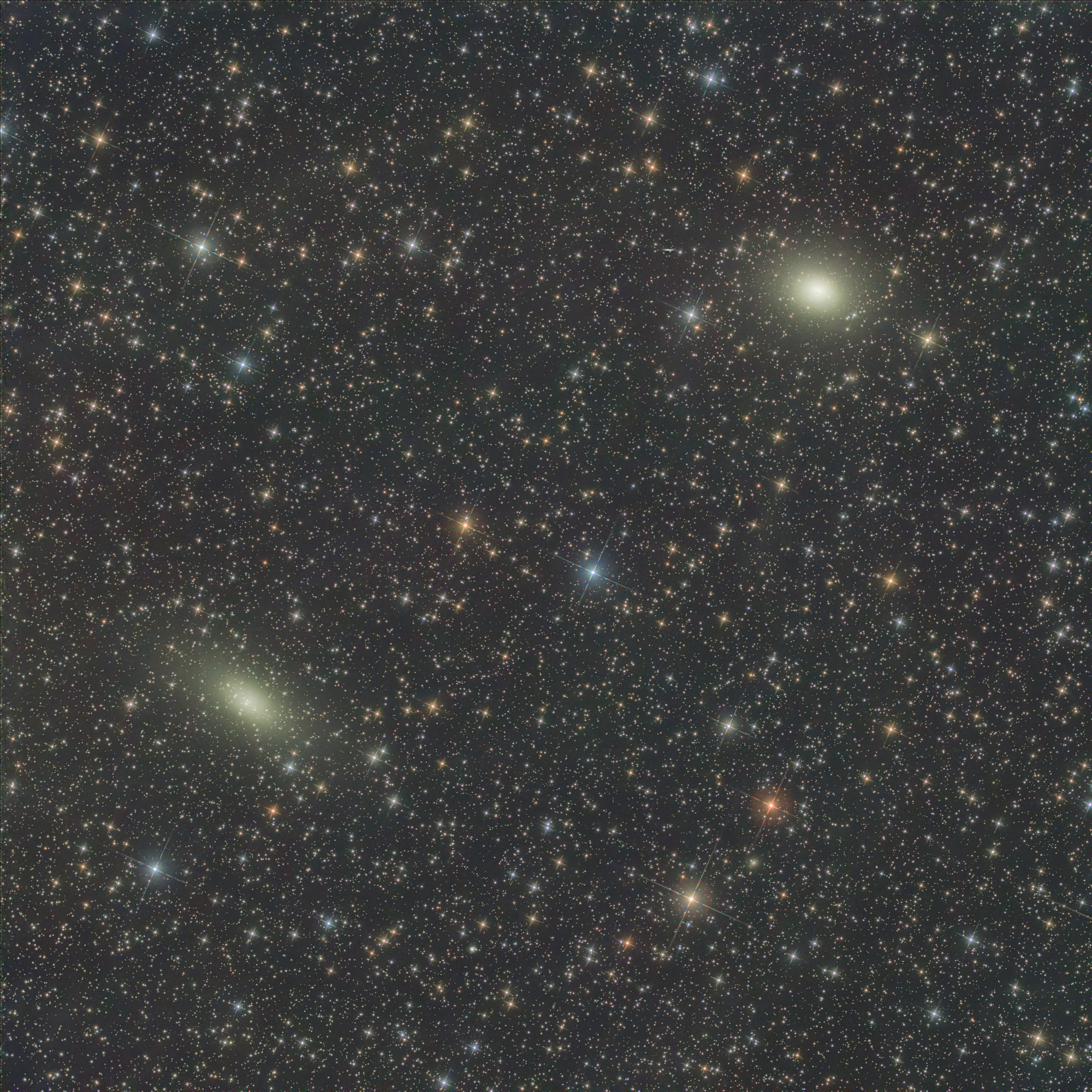 Galaxy NGC 147 on the left is a dwarf spherical galaxy about 2.58 Mly away in the constellation of Cassiopeia. NGC 147 is a member of the Local Group of galaxies and a satellite galaxy of the Andromeda Galaxy (M31). It forms a physical pair with the near right galaxy NGC 185, another distant satellite of M31.